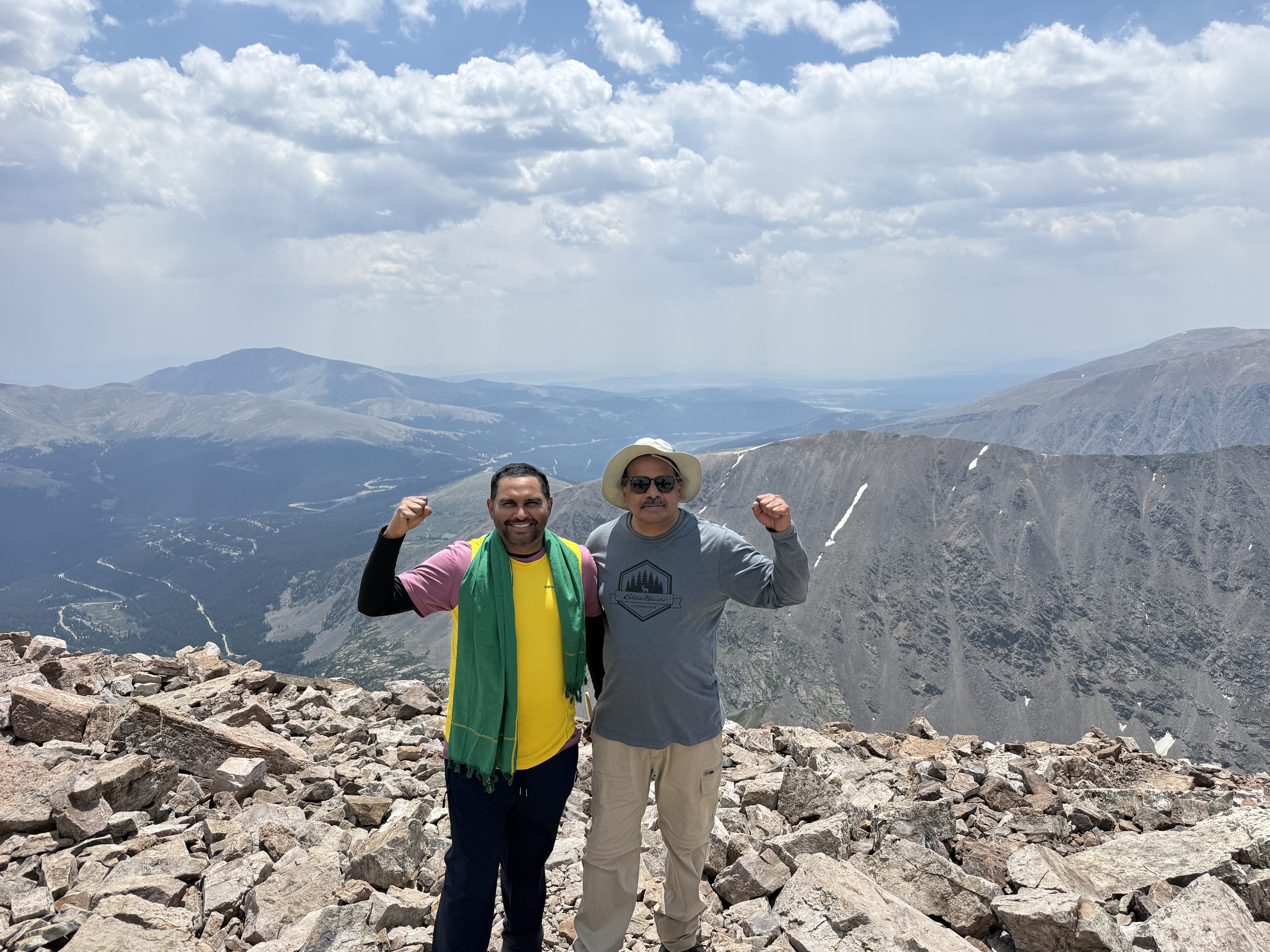 Two friends celebrating on the summit